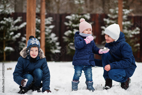Three kids playing in winter day. Brothers with yongest sister.