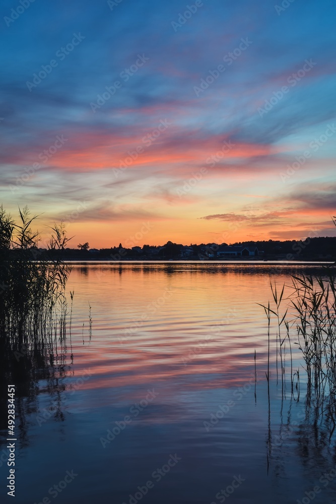 Beautiful colorful morning landscape. Wonderful sky over a Polish lake.