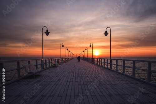 Beautiful morning seaside landscape. Wooden pier with a colorful sky in Gdynia, Poland. © shadowmoon30