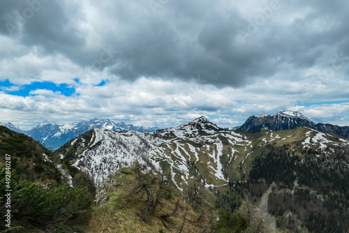 Panoramic view on Frauenkogel (Dovska Baba) with mountain peaks in the Karawanks, Carinthia, Austria. Borders Austria, Slovenia, Italy. Triglav National Park. Mount Triglav and Mangart in the back