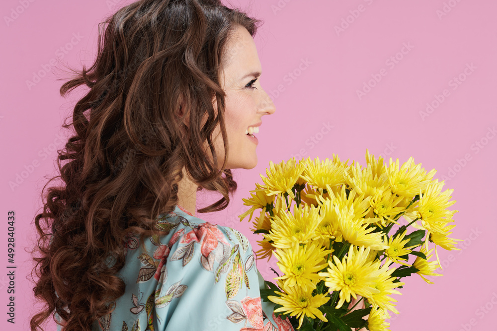 smiling elegant 40 years old woman in floral dress on pink smiling elegant 40 years old woman in floral dress on pink