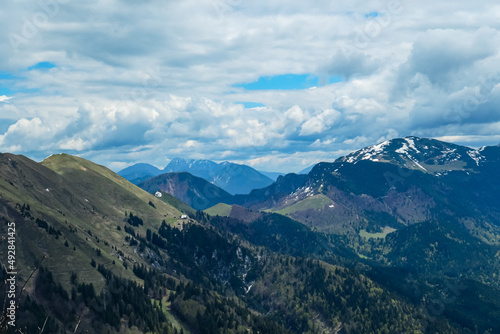 Panoramic view from Frauenkogel on mountain peaks in the Karawanks and Julian Alps, Carinthia, Austria. Borders Austria, Slovenia, Italy. Triglav National Park. Alpine meadows in spring. Woodland