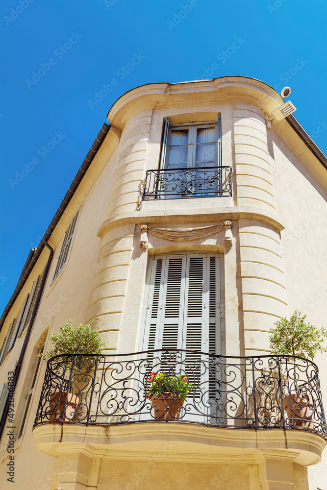 Building with french windows and balcony   in typical architecture style  for France 