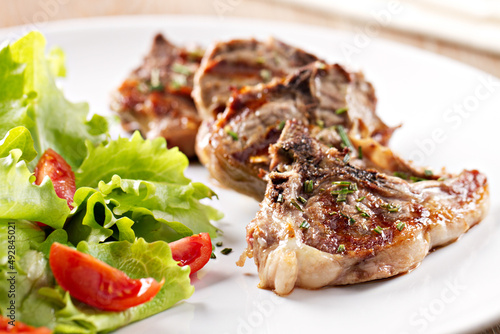 Grilled lamb chops with mixed salad. High quality photo