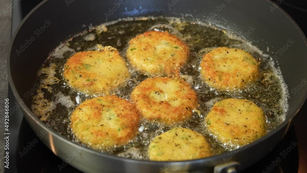 Close up shot of cheese snacks fried rotating in a frying pan. Preparing healthy tasty breakfast at home. 4k video Close up shot of cheese snacks fried rotating in a frying pan. Preparing healthy tasty breakfast at home. 4k video