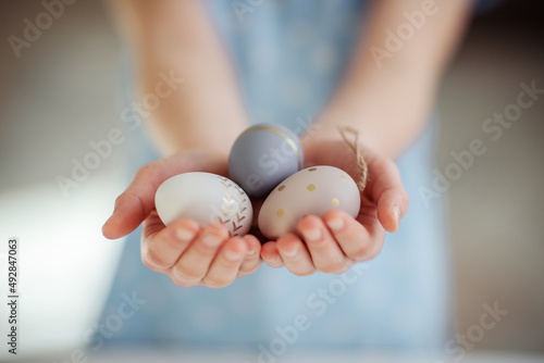 Closeup of tree Easter eggs in little child palms