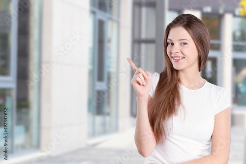 Young happy student posing on background