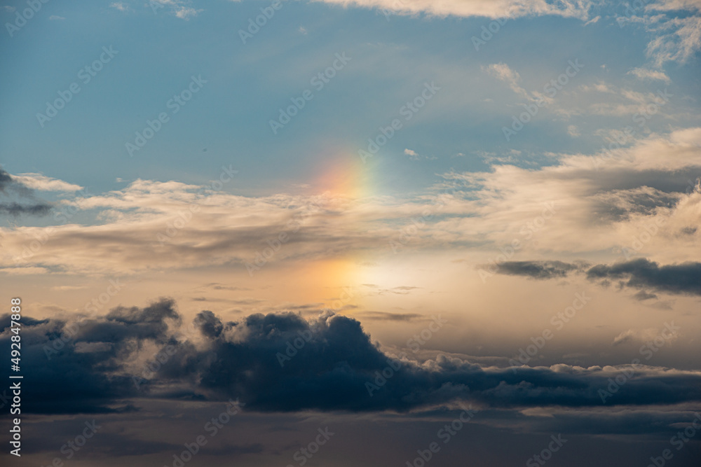 Rainbow in the clouds at sunset.