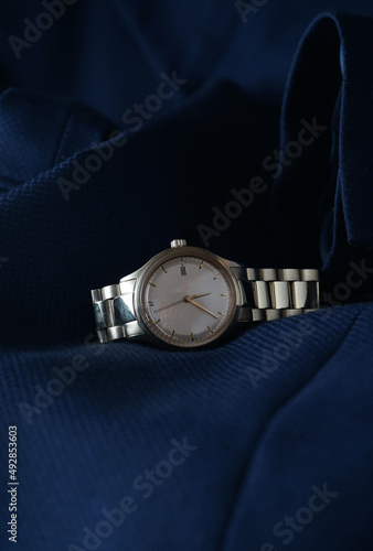 Elegant wrist watch closeup on blue background