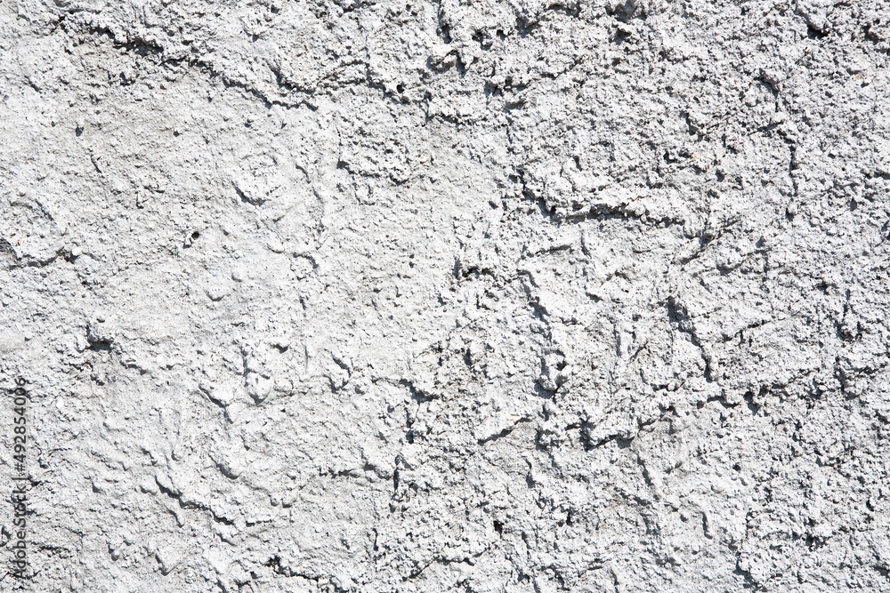 Obraz premium Building wall with roughcast plaster background with grainy effect surface