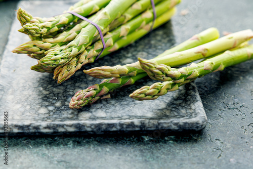 Bunch of green asparagus on a rustic background, fresh farm vegetables at the farmers market