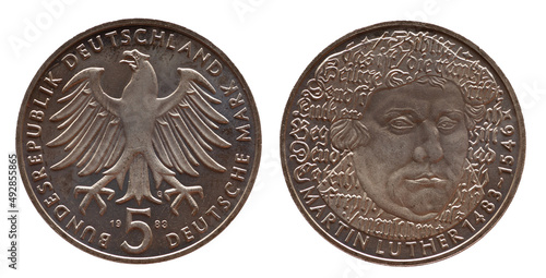 Germany - circa 1983 : a 5 German Mark coin of the Federal Republic of Germany with the cote of arm eagle and a portrait of the German Augustinian monk, theology professor and reformer Martin Luther