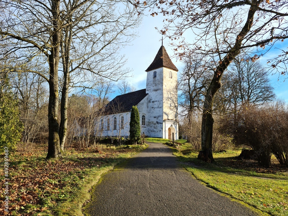 Small Lutheran church among the trees of park in the Latvian village of Sabile in autumn 2021