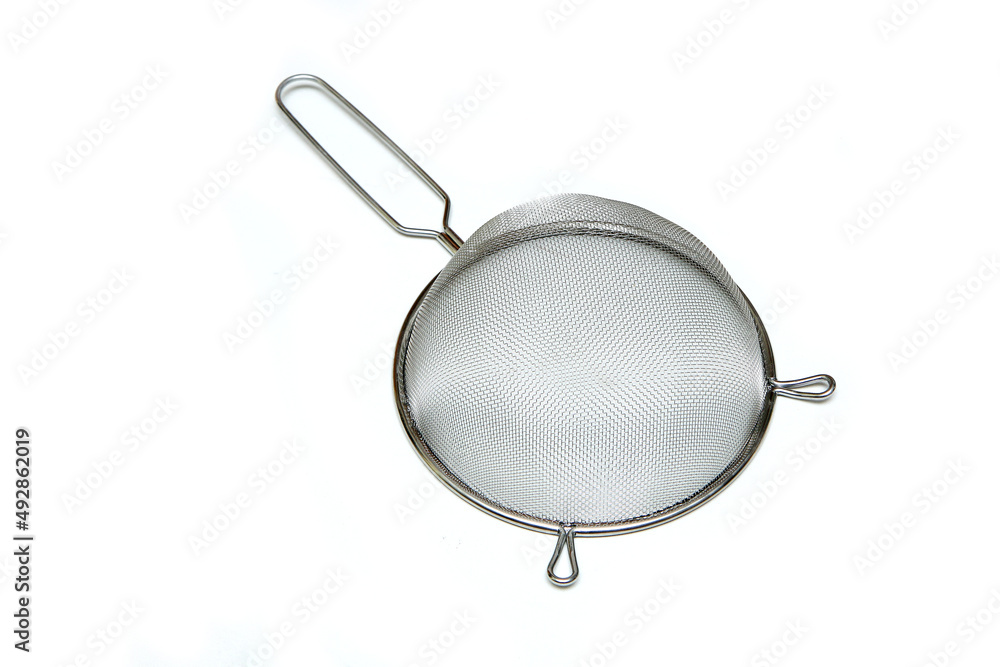 The simple new stainless strainer isolated in a white background. The simple new stainless strainer isolated in a white background.