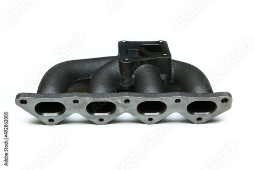 The new cast iron car engine air intake manifold isolated in a white background. 