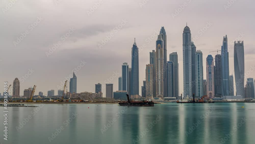 Panorama of modern skyscrapers in Dubai city at sunrise timelapse from the Palm Jumeirah Island. Panorama of modern skyscrapers in Dubai city at sunrise timelapse from the Palm Jumeirah Island.