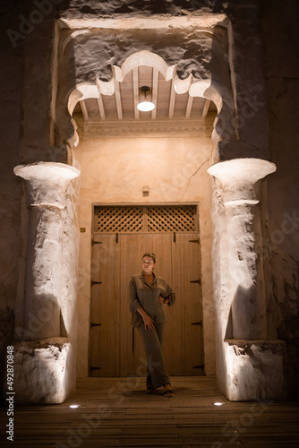 Woman tourist walking in Al Seef Meraas Dubai - old historical district with traditional Arabic architecture photo