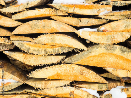 firewood natural background. Quarters of firewood are stacked in a pile, a background of firewo photo