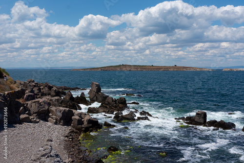 Sea surf day landscape. Sea waves with white foam breaks on stones. Sozopol. Bulgaria
