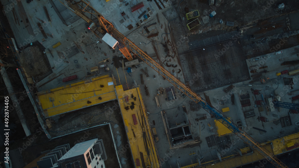 Aerial drone top down view on residential construction site in the city at end of the day