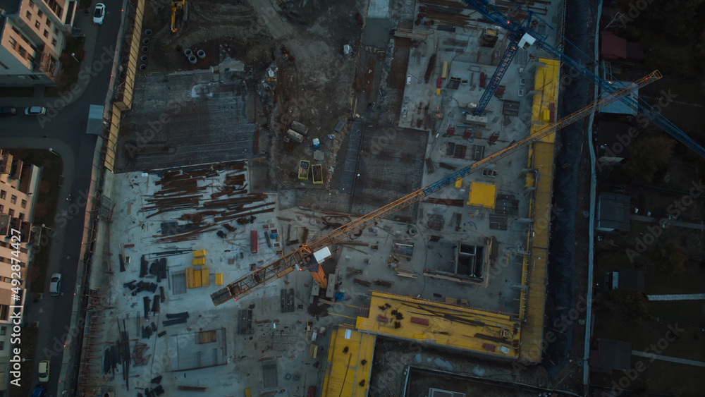 Aerial drone view on residential construction site in the city at end of the day