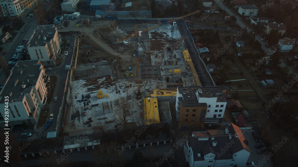 Aerial drone view on residential construction site in the city at end of the day
