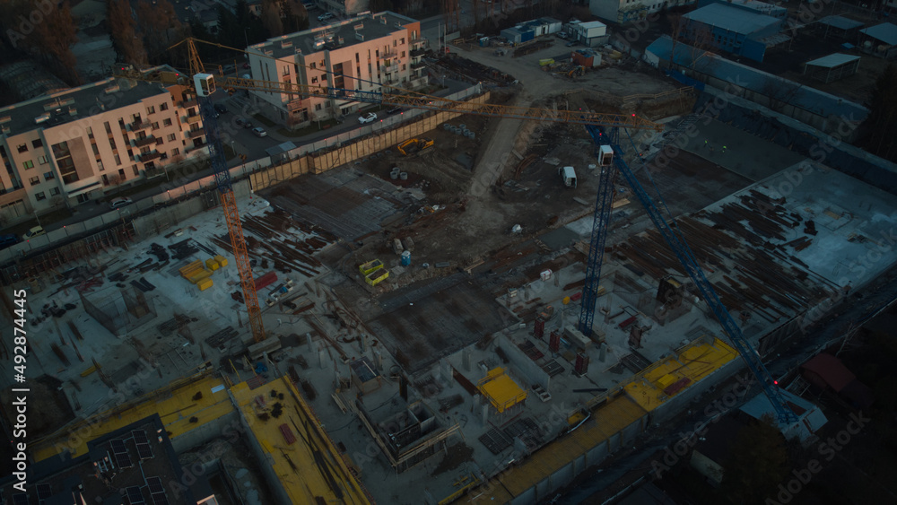 Aerial drone view on residential construction site in the city at end of the day