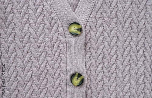 Textured surface of a knitted sweater, top view, close-up. Soft lilac pastel wool background. Stay at home, cozy, feminine concept.