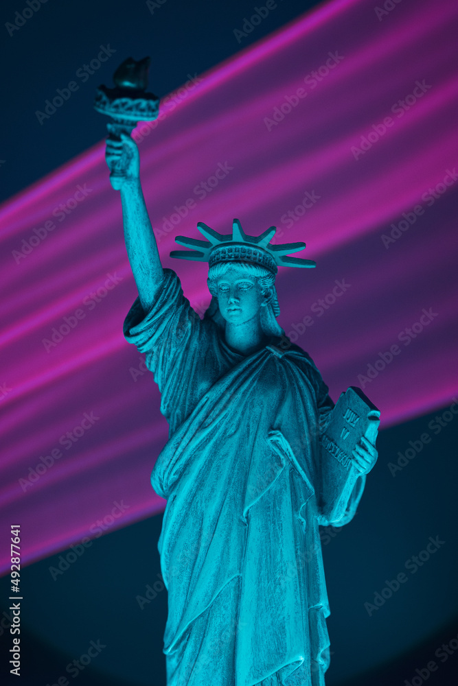 Obraz premium Statue of liberty close up with neon illumination background. USA freedom futuristic concept.