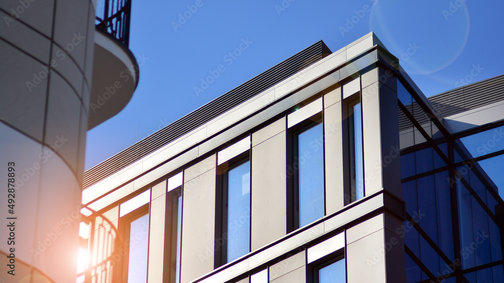Obraz premium Modern office building in the city with windows and steel and aluminum panels wall.