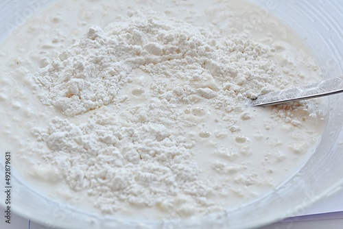 white flour in a glass bowl prepared for pancake dough