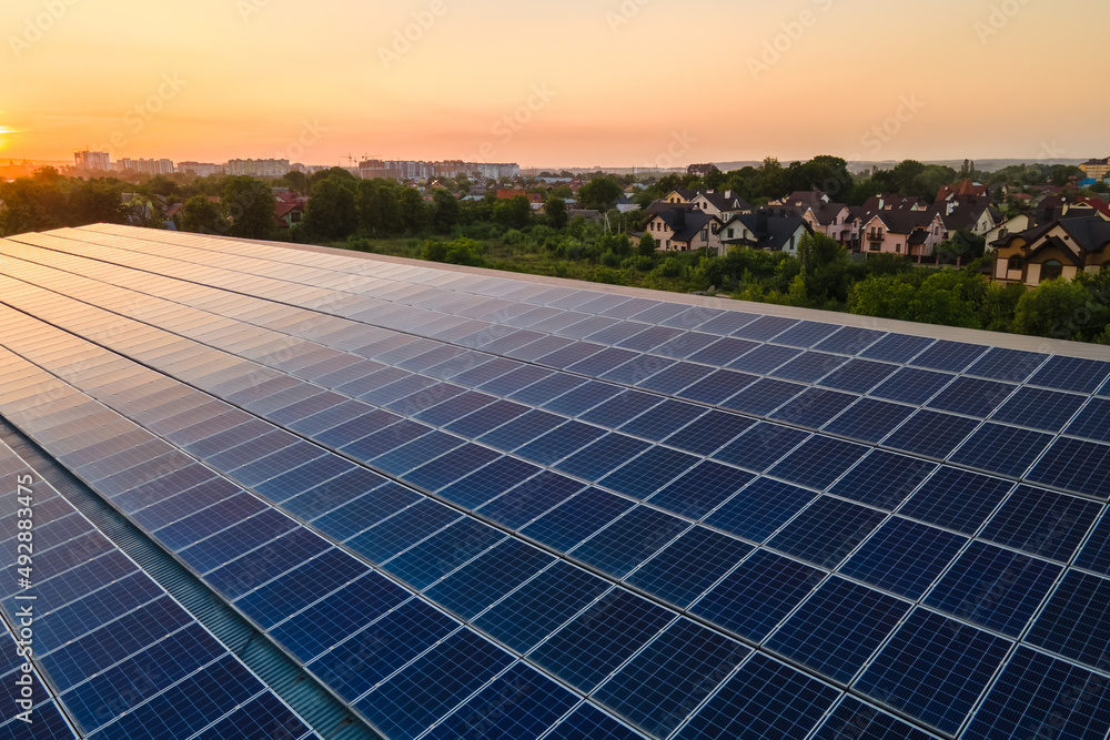 custom made wallpaper toronto digitalBlue photovoltaic solar panels mounted on building roof for producing clean ecological electricity at sunset. Production of renewable energy concept