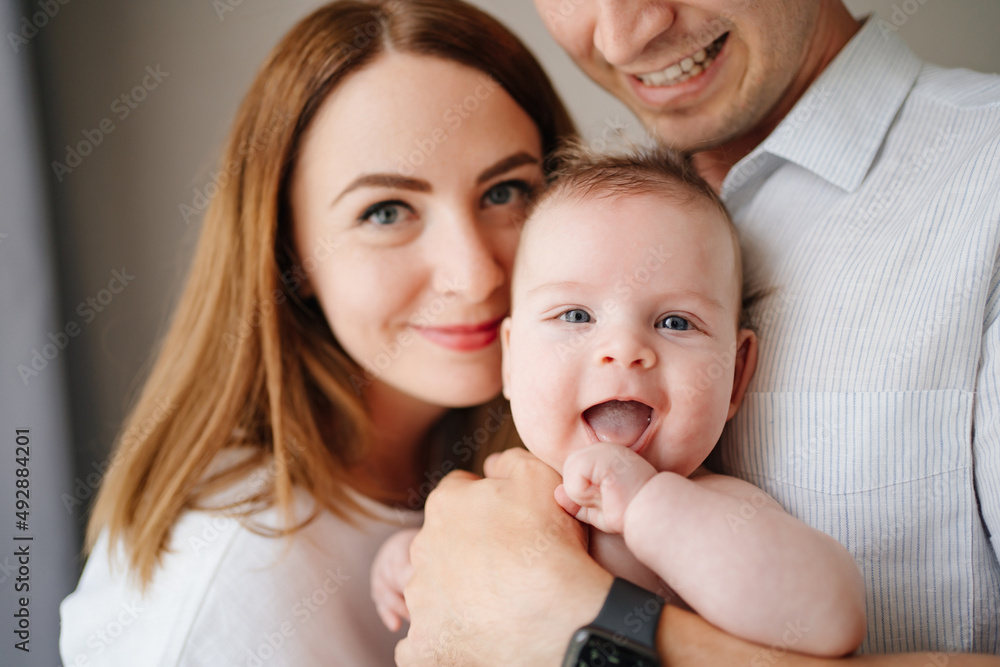 a happy family with a newborn baby. mom, dad and baby.