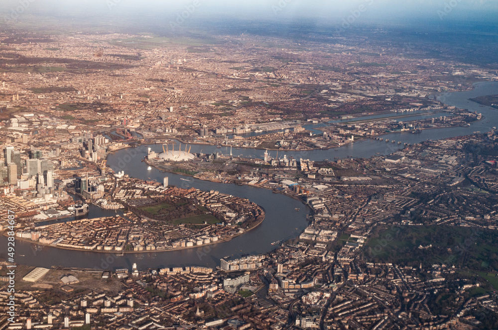 Aerial view of The Isle of Dogs, River Thames, Greenwich and Thames flood barrier, London.