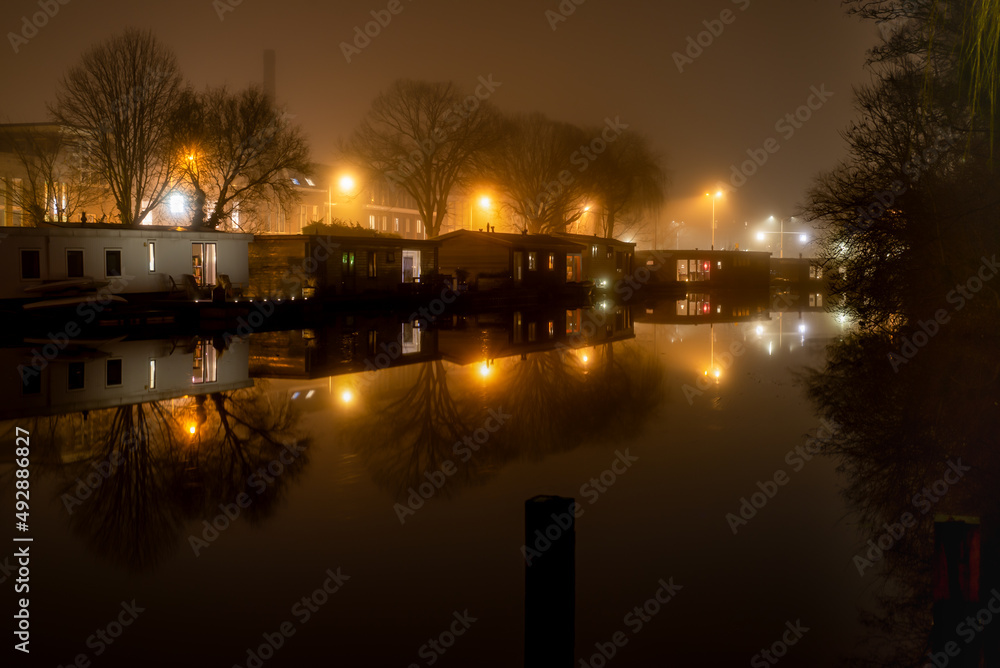 12 January 2022, Leiden, Netherlands, Image of the boathouses on the canal, night shoot