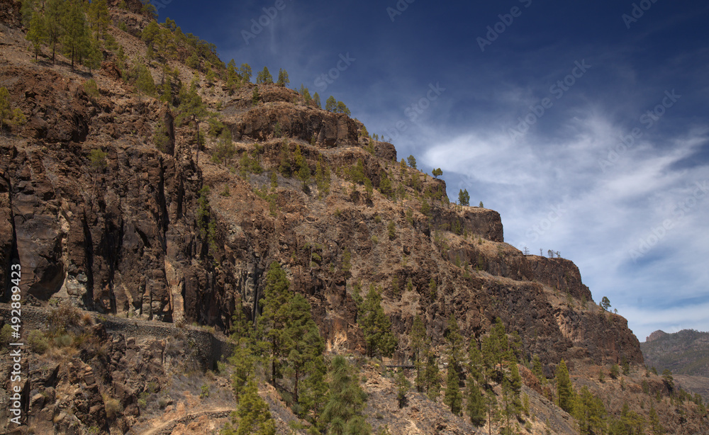 Gran Canaria, landscape of the southern part of the island along Barranco de Arguineguín steep and deep ravine
with vertical rock walls, circular hiking route starting at a hamlet Barranquillo Andres
Gran Canaria, landscape of the southern part of the island along Barranco de Arguineguín steep and deep ravine
with vertical rock walls, circular hiking route starting at a hamlet Barranquillo Andres