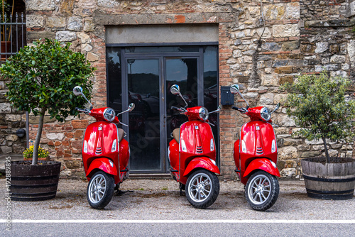 red scooter in front of a church