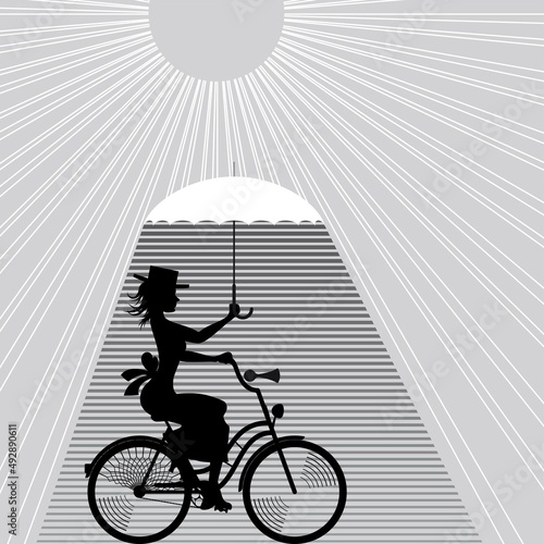 Cyclist with an umbrella on a hot day