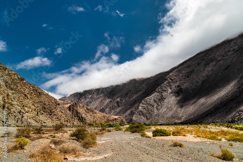 Truck tracks on dirt road between mountains in Salta, Argentina