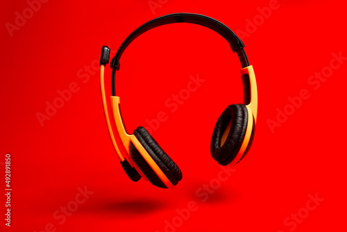 orange heaphones on red background 