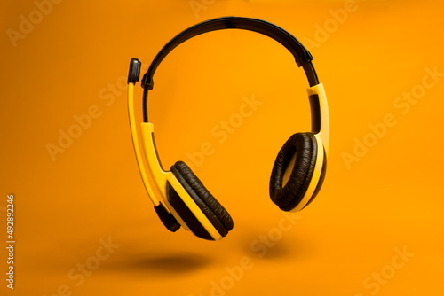 yellow headphones  on orange background 