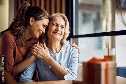 Happy senior woman enjoys in daughter's affection on Mother's day. photo