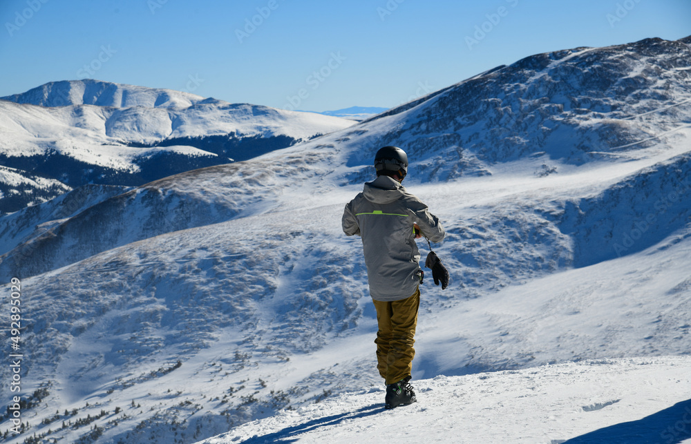 Skier standing on the top of Peak 8 at the Breckenridge Ski Resort in Colorado. Active lifestyle, extreme winter sports.