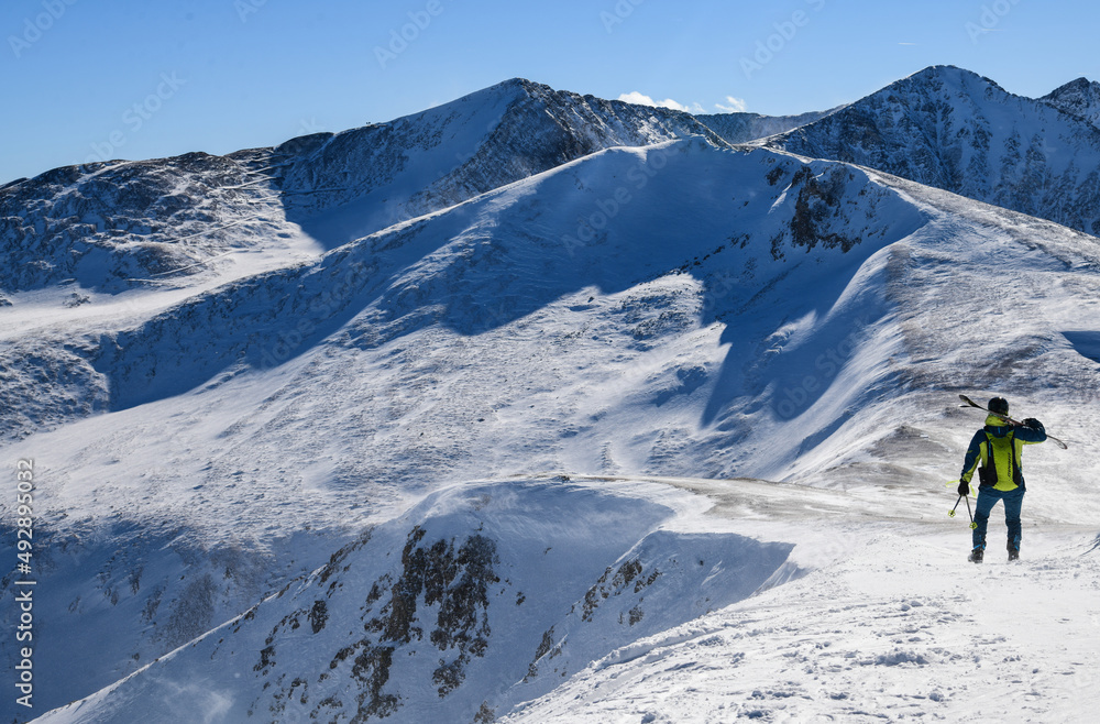 Skier standing on the top of Peak 8 at the Breckenridge Ski Resort in Colorado. Active lifestyle, extreme winter sports.