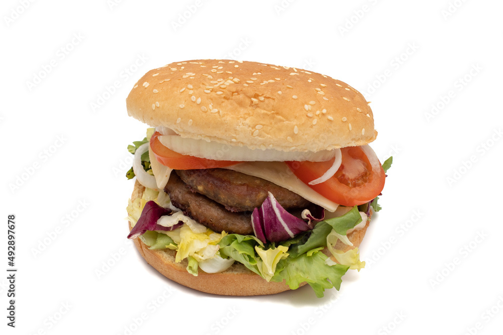 A double meat burger, with the ingredients, lettuce, cabbage, cucumber, tomato, onion, cheese, ketchup, mayonnaise. Isolated on white background. One of the most consumed snacks in the world. A double meat burger, with the ingredients, lettuce, cabbage, cucumber, tomato, onion, cheese, ketchup, mayonnaise. Isolated on white background. One of the most consumed snacks in the world.