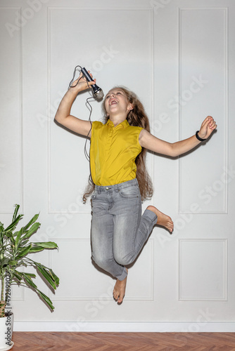 A child sings in a jump photo