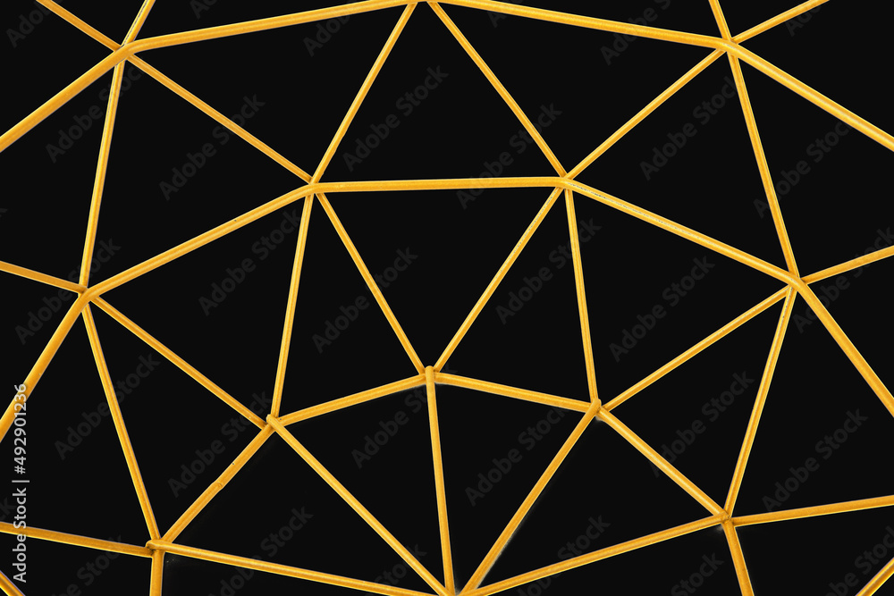 closeup of golden trangle shaped isolated on black background closeup of golden trangle shaped isolated on black background