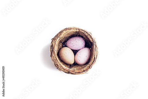 Nest with decorated eggs isolated on white background. Easter concept. Top view