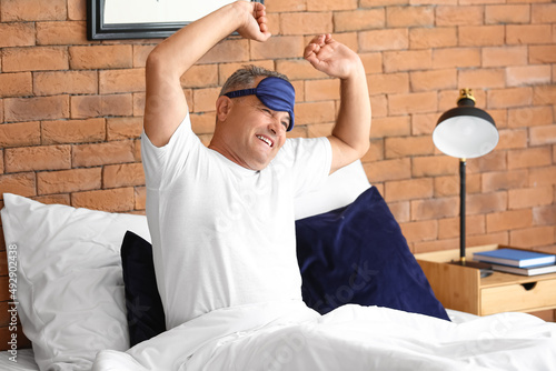 Mature man with sleep mask ...