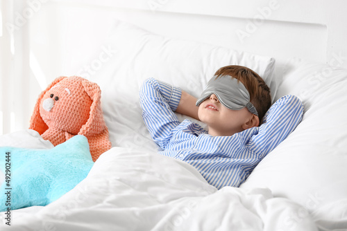 Little boy sleeping in bed